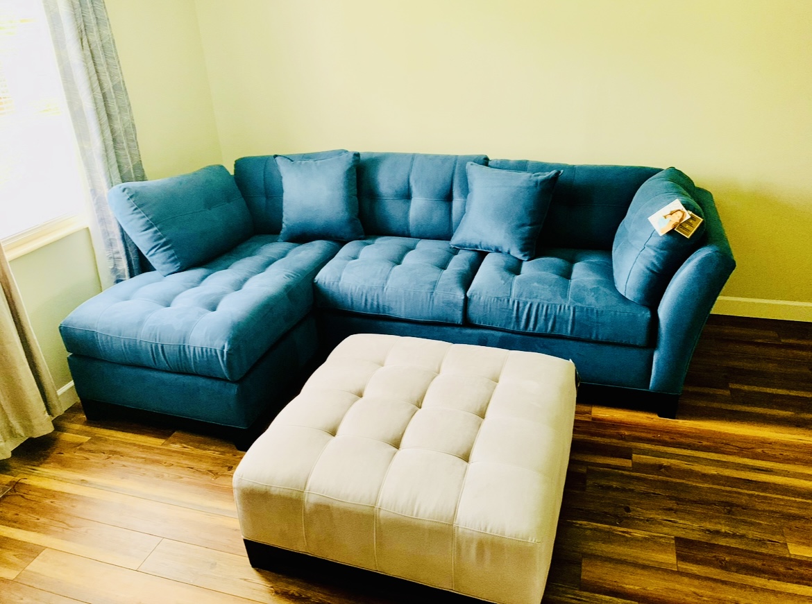 ROOMS TO GO® Cindy Crawford Collection blue sectional with silver ottoman ROOMS TO GO® Cindy Crawford Collection blue sectional with silver ottoman