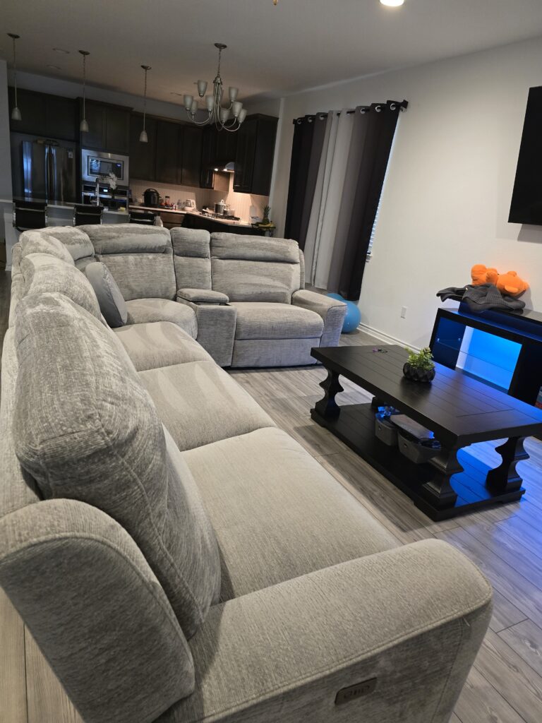 Like - New, Gray Modern Reclining Sectional with Convenient Charging Ports and Cup Holders.
